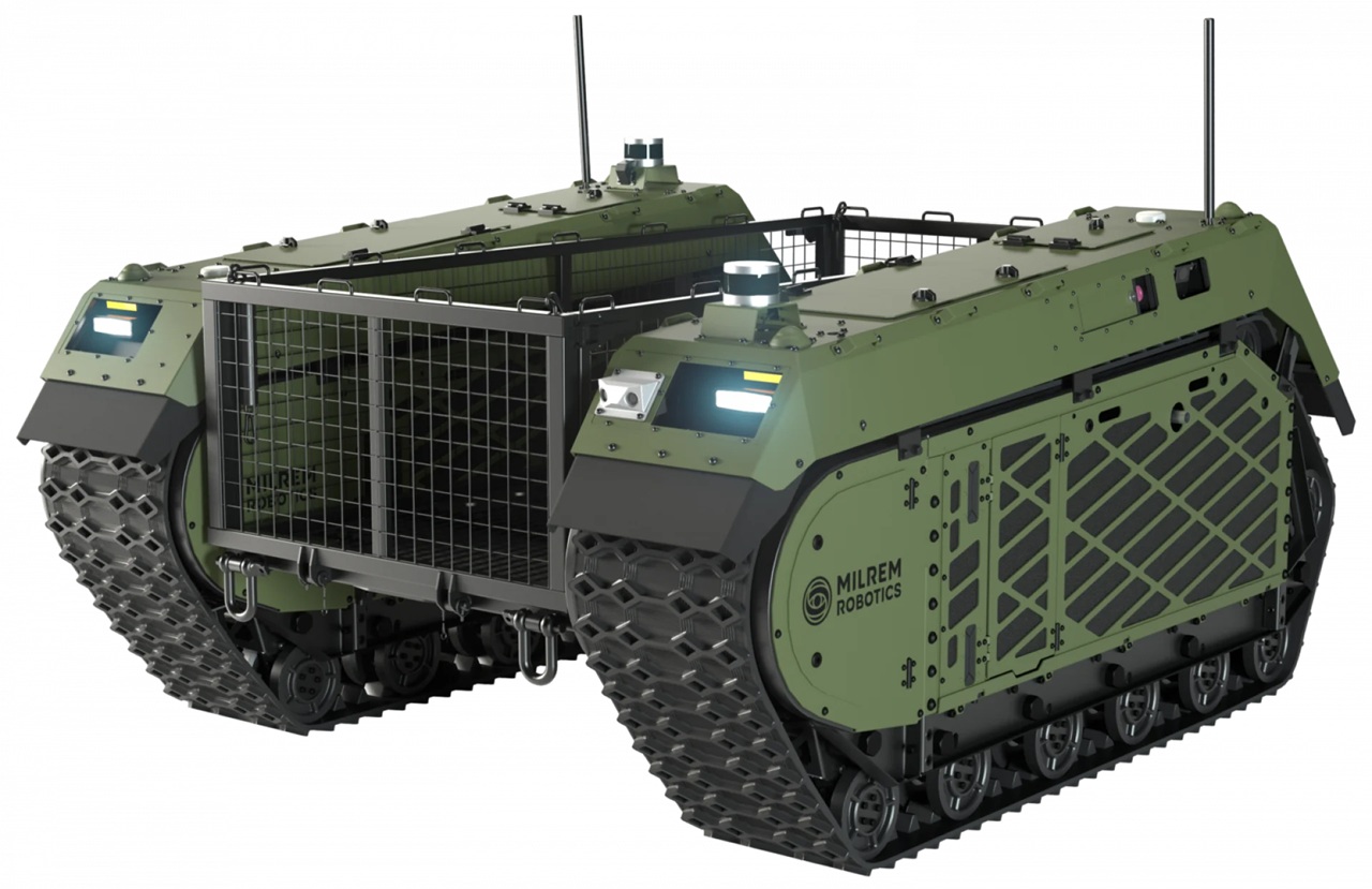 THeMIS Green tracked unmanned ground vehicle with armored panels and front mesh grille, Milrem Robotics branding visible on the side.