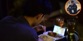 Person eating takeout meal at a dimly lit table with two drinks; a phone or photo screen glows on the tray. Inset: a uniformed security officer looks at a tablet outdoors.